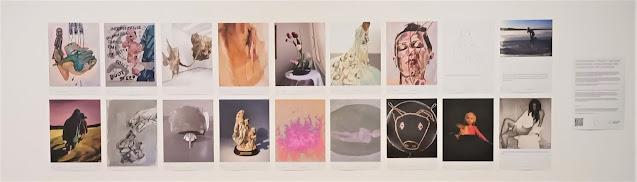 A series of 18 art posters in a double row on a white wall. Predominant colours are pale yellows an creams, pink, and blacks.